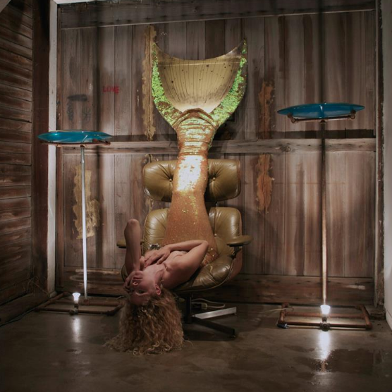 mermaid indigo child upside down in a chair